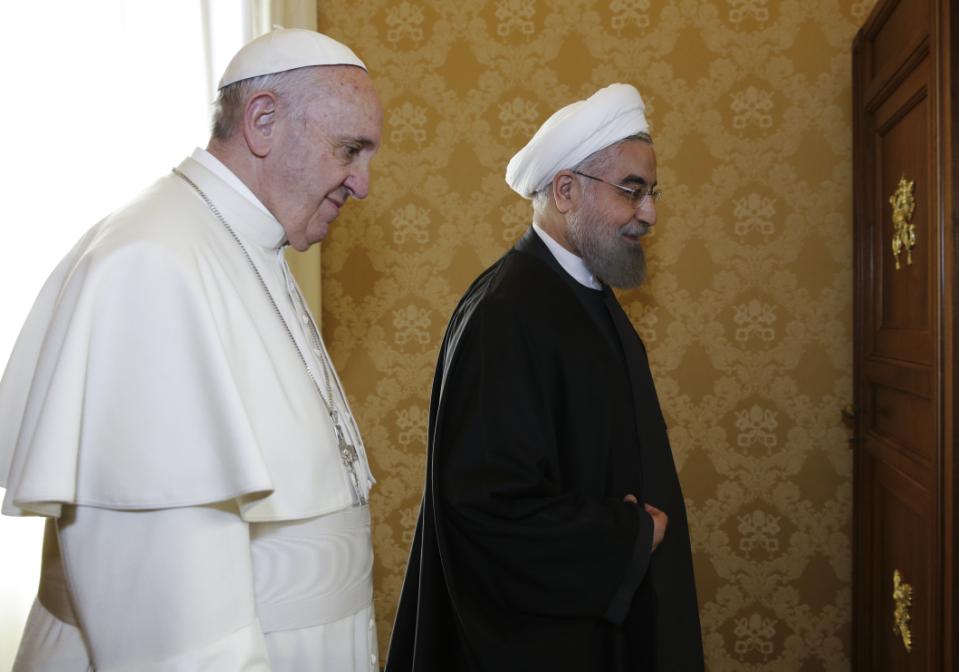 Pope Francis and Iranian President Hassan Rouhani, right, meet on the occasion of their private audience at the Vatican,Tuesday, Jan. 26, 2016. Irans president has paid a call on Pope Francis at the Vatican during a European visit aimed at positioning Tehran as a potential top player in efforts to resolve Middle East conflicts, including Syrias civil war. (AP Photo/Andrew Medichini, Pool)