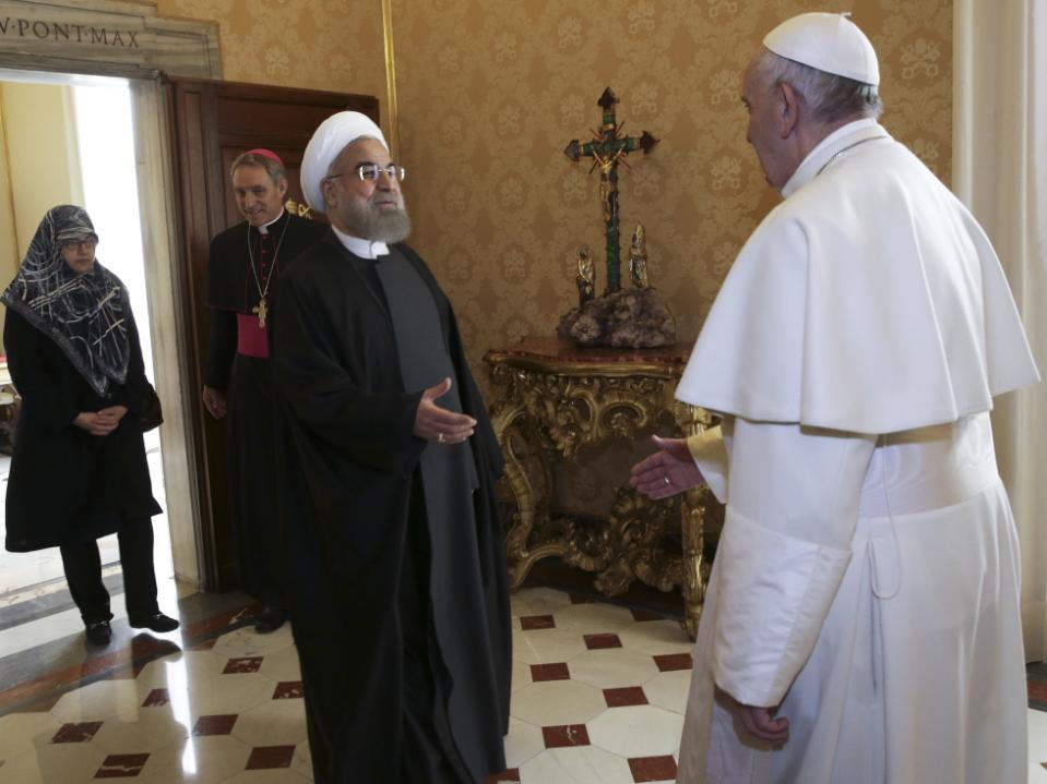 Pope Francis welcomes Iranian President Hassan Rouhani, left, on the occasion of their private audience at the Vatican,Tuesday, Jan. 26, 2016. Irans president has paid a call on Pope Francis at the Vatican during a European visit aimed at positioning Tehran as a potential top player in efforts to resolve Middle East conflicts, including Syrias civil war. (AP Photo/Andrew Medichini, Pool)