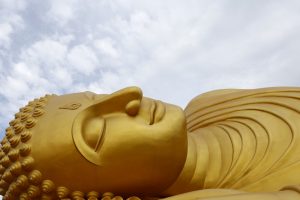 epa05550005 A picture made available 21 September 2016 shows a giant reclining golden Buddha, at a Buddhist temple named Wat Phranon Laem Pho, on Ko Yo island, Songkhla province, southern Thailand, 18 September 2016. Thailand's many Buddhist temples and large Buddha statues are among attractions highlighted for the Kingdom's healthy tourism industry, which is expected to reach a record this year of more than 32 million arriving tourists. Despite Thailand's political situation and a recent spate of bombings, Thai tourism continues to surge. United Nations World Tourism Day celebrations will be held in Thailand and across the world on 27 September 2016.  EPA/BARBARA WALTON