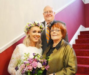 Connie Bell, 21, with Grandmother Margaret White, and  Grandfather Michael White. Connie ditched her wedding dress for her  grandma's 50 year old floral lace number. See rossparry copy RPYDRESS:A beautiful bride ditched her expensive wedding dress on the big day after falling in love with her grandmother's 50-year-old floral lace number. Connie Bell, 21, nee Pickup, decided to keep her £1,000 "simple" wedding dress in reserve for her special day for the same dress her granny Margaret White, 71, wore on her wedding day in 1966 - and it was a perfect fit. When bride Connie was told her wedding venue had been cancelled two weeks before her wedding - her grandmother decided to cheer her up by showing her the dress she wore.